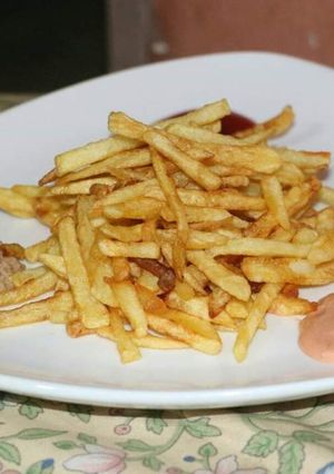 A picture of Fries with 3 sauces.