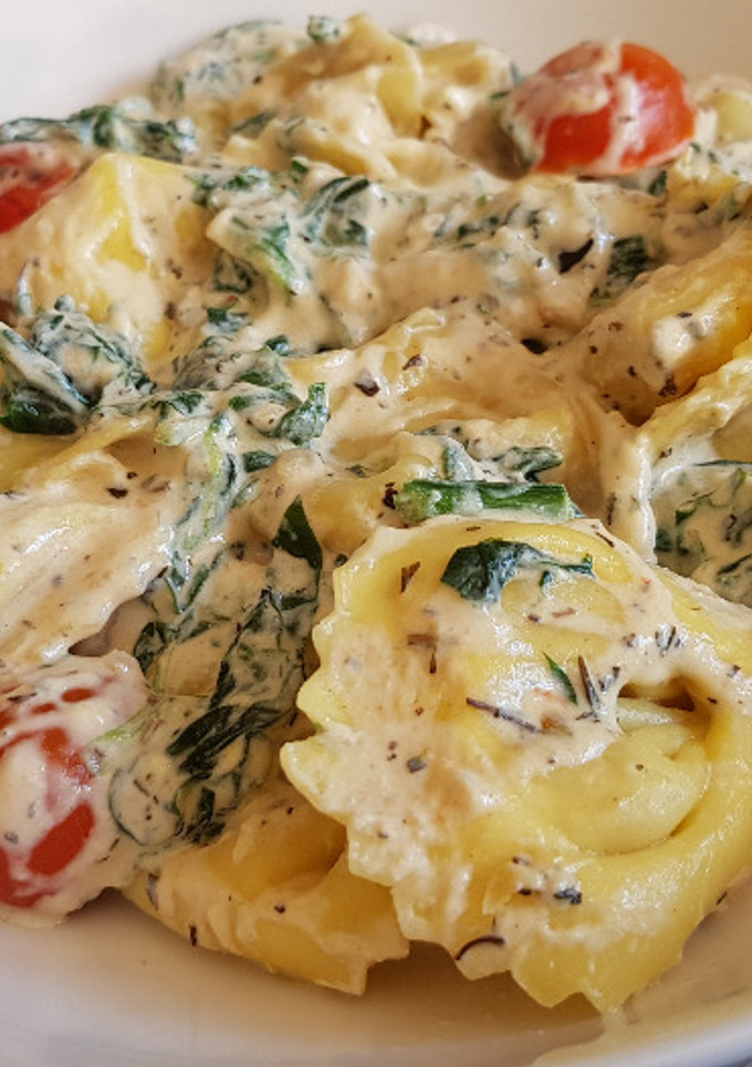 Una foto de Tortellinis en salsa con tomate y espinacas
