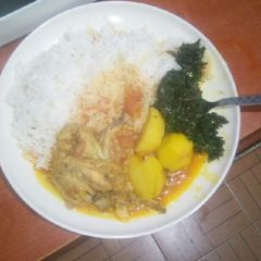 A picture of Chicken wings mixed with potatoes stew,,and spinach.