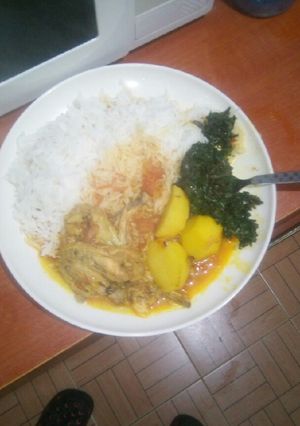 A picture of Chicken wings mixed with potatoes stew,,and spinach.