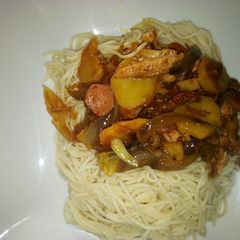 A picture of Sausage and chicken sauce with spaghetti.