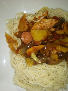 A picture of Sausage and chicken sauce with spaghetti.