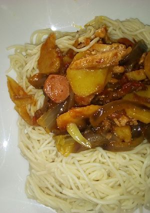 A picture of Sausage and chicken sauce with spaghetti.