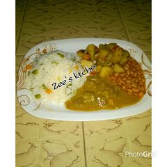 Basmati rice,baked potato, chicken curry soup wit baked beans A picture of Basmati rice,baked potato, chicken curry soup wit baked beans.