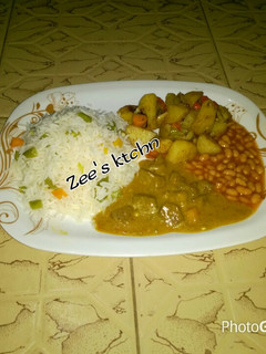 A picture of Basmati rice,baked potato, chicken curry soup wit baked beans.
