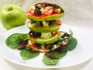 Green Apple Salad with cheese dry fruits and strawberry sauce