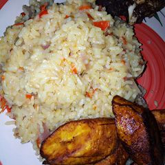 Local rice jollof and fried plantain with fried beef A picture of Local rice jollof and fried plantain with fried beef.