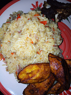 A picture of Local rice jollof and fried plantain with fried beef.