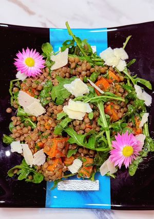 A picture of Spiced sweet potato, puy lentil and rocket with honey and parmesan cheese.