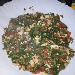 A picture of Fried Eggs mixed with spinach.