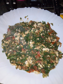 A picture of Fried Eggs mixed with spinach.