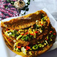 A picture of Panchmel Dal or Mixed Lentils Chilla with veggies.