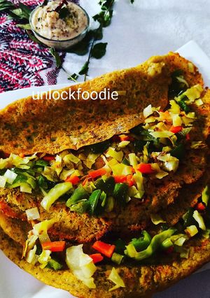 A picture of Panchmel Dal or Mixed Lentils Chilla with veggies.