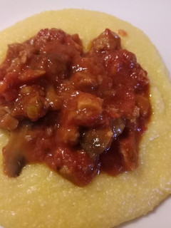 A picture of Polenta with sausage and porcini mushrooms.