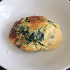 A picture of Baked eggs and spinach.