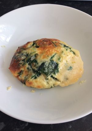 A picture of Baked eggs and spinach.