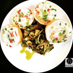 A picture of Moimoi with green pepper and onion sauce.