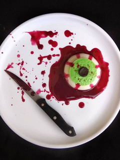 A picture of Halloween Bloody Eye Representing Coconut Milk and Banana Pudding with twist of Beetroot Sauce.