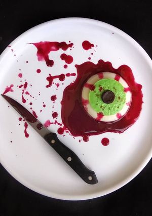 A picture of Halloween Bloody Eye Representing Coconut Milk and Banana Pudding with twist of Beetroot Sauce.