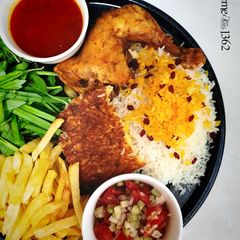 A picture of Zereshk Polo ba Morgh (Persian Barberry Rice with Chicken).