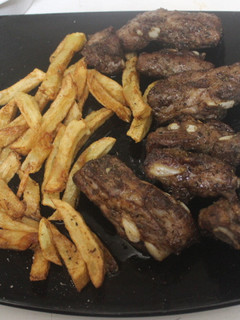 Una foto de Costillar adobado con patatas fritas