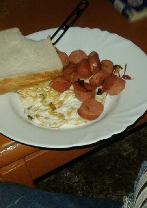 A picture of Fried egg with fried sausages.