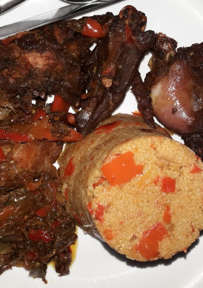 A picture of Jollof couscous with peppered chicken.