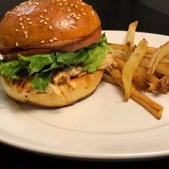 A picture of Homemade Chicken burger with vegetables.