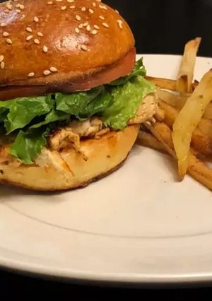 A picture of Homemade Chicken burger with vegetables.
