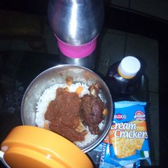 A picture of White rice and stew with fried chicken.