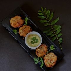 A picture of Poha Vada with Green Mango Chutney.
