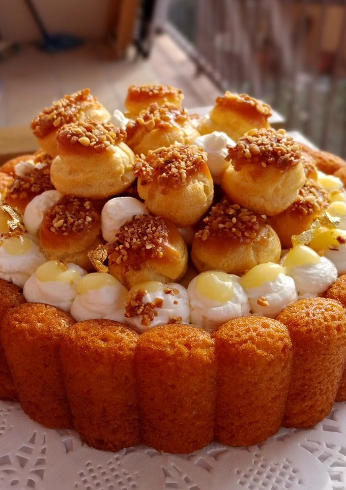 Una foto de Bizcocho de vainilla y almendras con nata y profiteroles rellenos de lemon curd y toffee