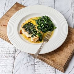 Pan Roasted Hake with black butter sauce and seasonal veg A picture of Pan Roasted Hake with black butter sauce and seasonal veg.