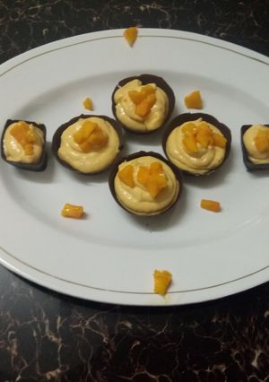 A picture of Mango mousse with choco cup.
