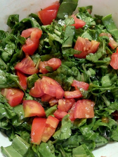 A picture of Spinach and tomato salad.