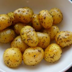 A picture of Pot roast potatoes with garlic and herbs.