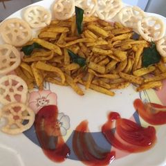 A picture of Masala French fries with ketchup.