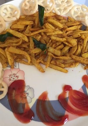 A picture of Masala French fries with ketchup.