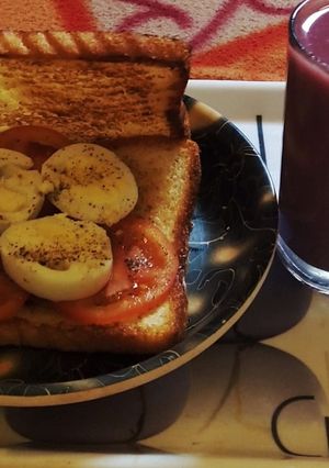 A picture of Boiled Egg Sandwich With Pomegranate Juice.