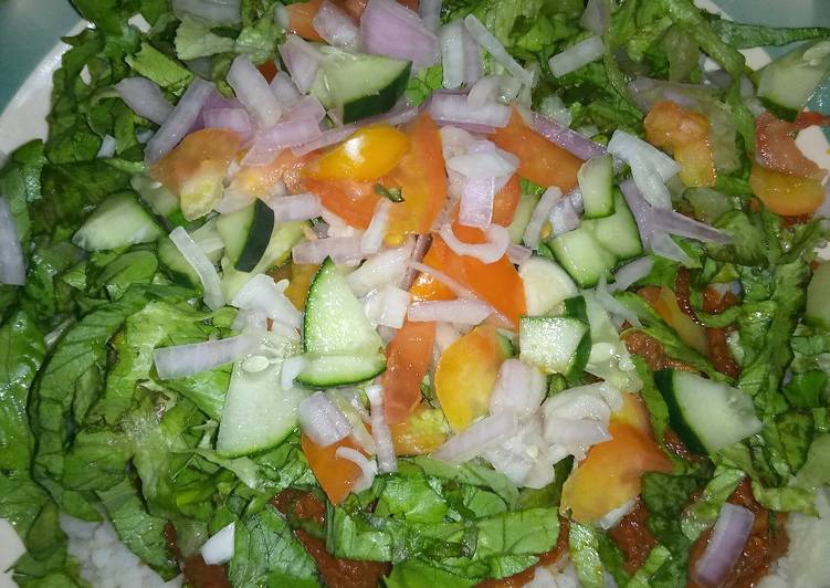 Rice and stew with salad