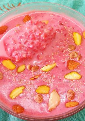 A picture of Daliya kheer with dry fruit and juice beetroot.