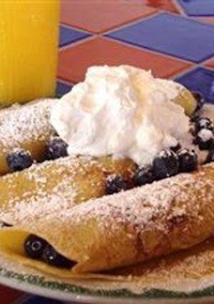 A picture of Crepes with blueberry purée.