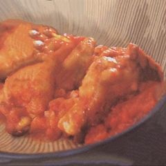 A picture of Braised chicken drumsticks with tomato .