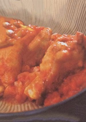 A picture of Braised chicken drumsticks with tomato .