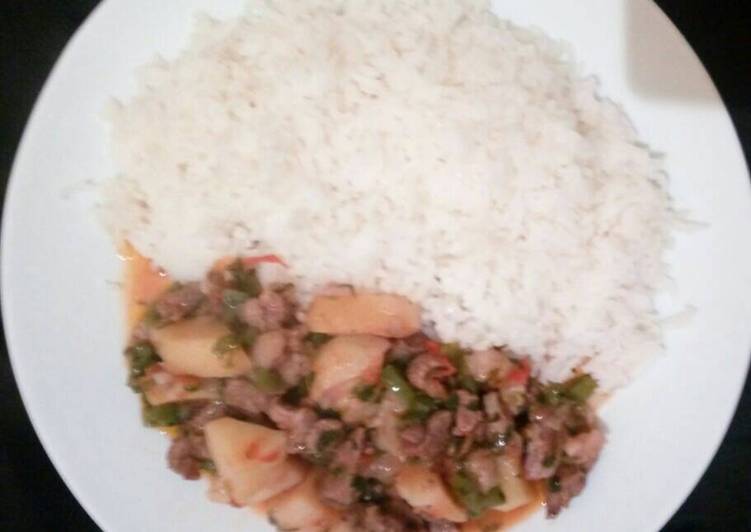 Potatoes and beef stew served with Rice