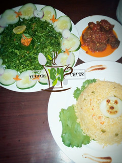 A picture of Jollof Rice served with salad and pepper meat #contest.