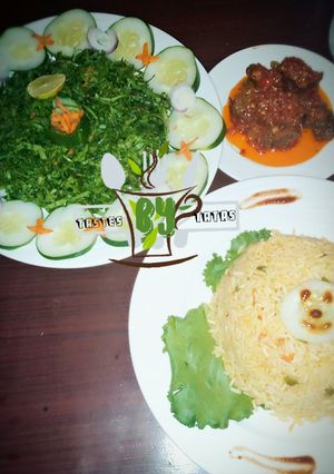 A picture of Jollof Rice served with salad and pepper meat #contest.