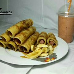 A picture of Honey Dripping Hot dog Pancakes with banana Toppings & Smoothies.