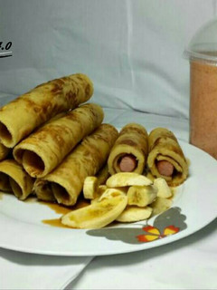 A picture of Honey Dripping Hot dog Pancakes with banana Toppings & Smoothies.
