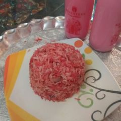 A picture of Rose sharbat with pink rice.